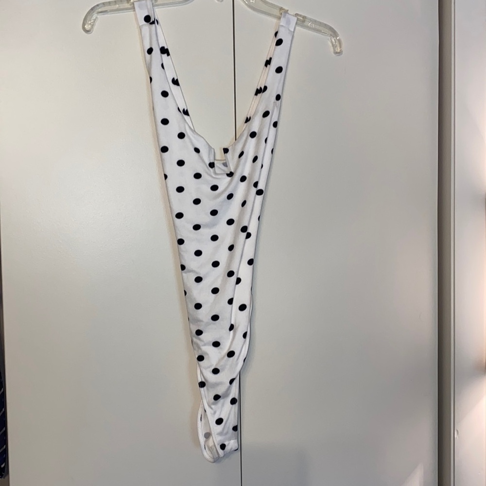 Lulus black & white polka dot body suit, “U” bar plunge, criss cross back